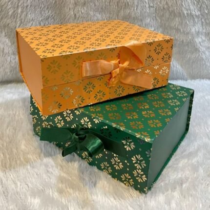 Elegant corporate gift boxes with gold foil design and ribbons, perfect for professional gifting occasions.