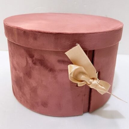 Pink Suede Round Surprise Box with lid and beige satin bow, ideal for elegant corporate gifting.