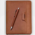 Corporate gifting: Brown 2025 A5 diary with pen clipped to cover, perfect for organized planning.