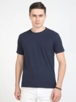 Man models navy Sustainable Crew Neck T-shirt and white pants, ideal for premium corporate gifting.