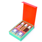 Corporate gift box with red lid, two smaller boxes, and four snack tubes on white background.